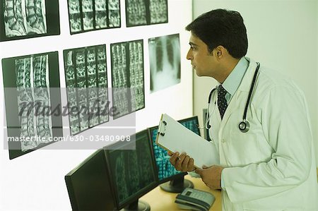 Male doctor examining X-Ray report