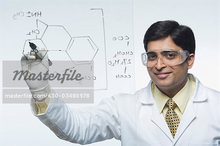 Scientist writing chemical formula