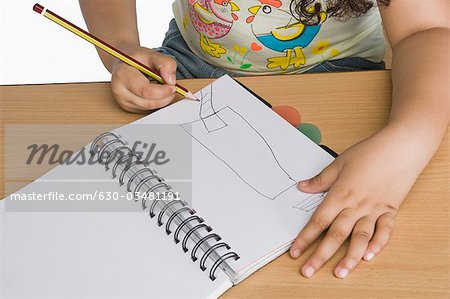 Mid section view of a girl drawing a picture