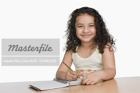 Portrait of a girl writing and smiling