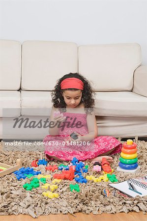 Girl playing with toys in a living room