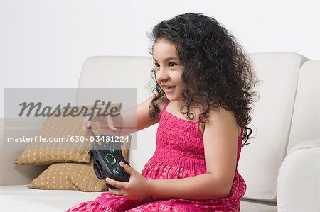 Girl playing a video game and smiling