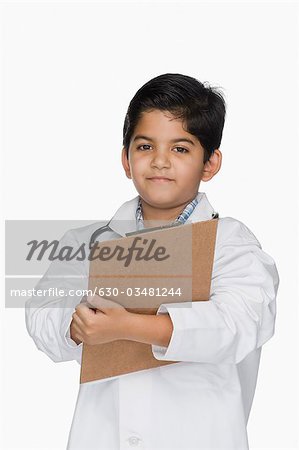 Boy imitating a doctor and holding a clipboard