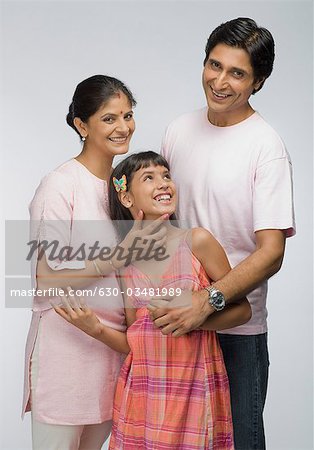 Parents smiling with their daughter