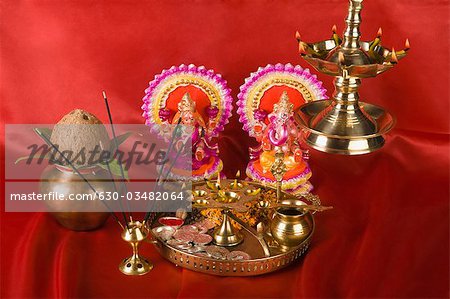 Diwali thali in front of idols of Lord Ganesha and Goddess Lakshmi