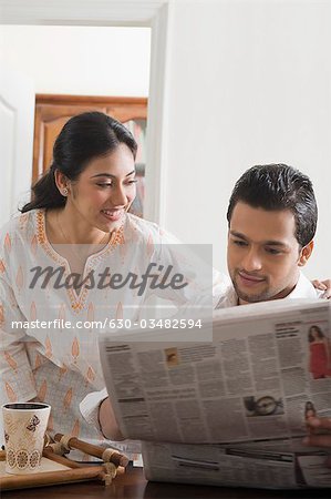 Couple reading a newspaper