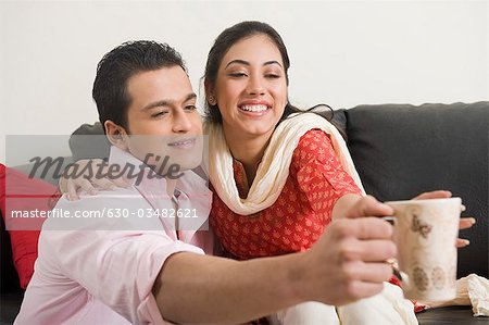 Couple having fun with a cup of coffee
