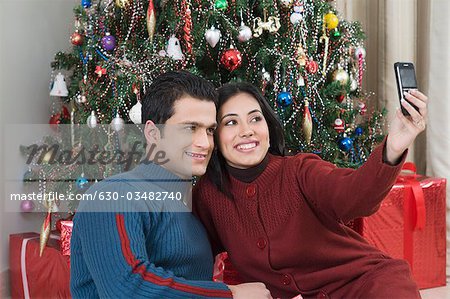 Couple taking a picture of themselves with a camera phone