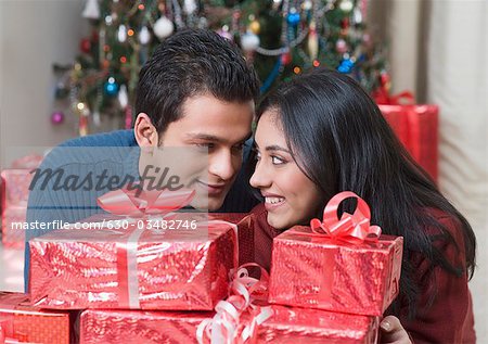 Couple smiling with Christmas presents