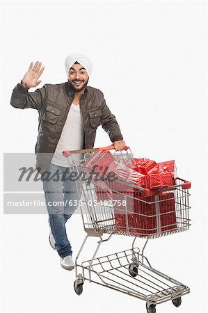 Man pushing a shopping cart of gifts