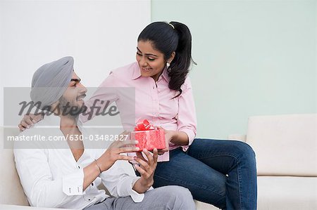 Woman giving a present to her husband