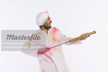 Man playing Holi with a pichkari