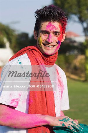 Man holding a plate of gulal on Holi