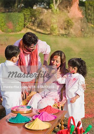 Family celebrating Holi with colors