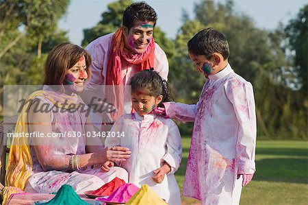 Family celebrating Holi with colors