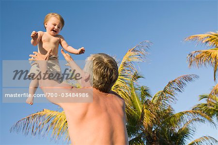 Grandfather Tossing Grandson in Air