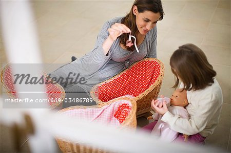 Pregnant woman playing with little girl