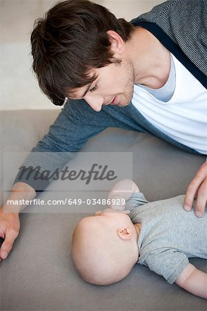 Man with baby on sofa