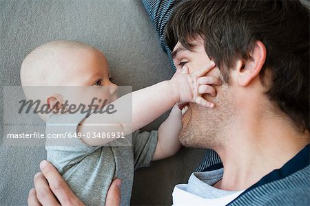 Baby touching fathers face Baby touching fathers face