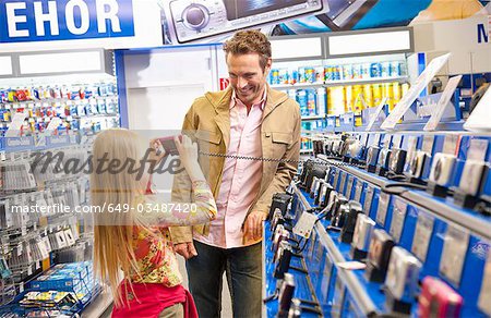 Girl taking a photo of her father