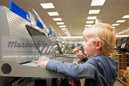 Little boy is testing a laptop computer