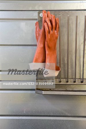 Fabric coating plant, rubber gloves drying on rack