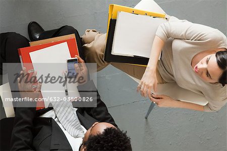 Businesswoman meeting with associate, overhead view