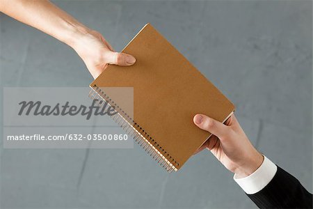 Handing colleague notebook