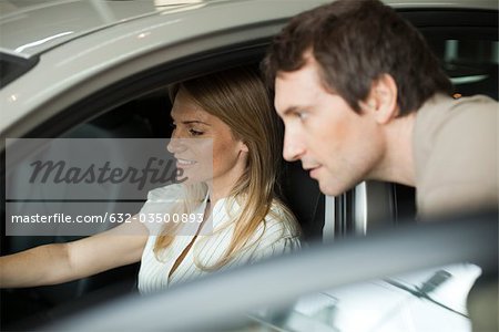 Couple checking out new car