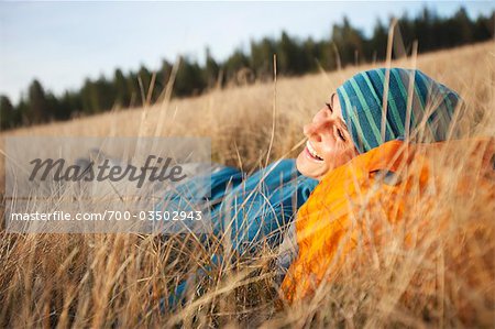 Woman Lying in Long Grass near Deschutes River, Oregon, USA