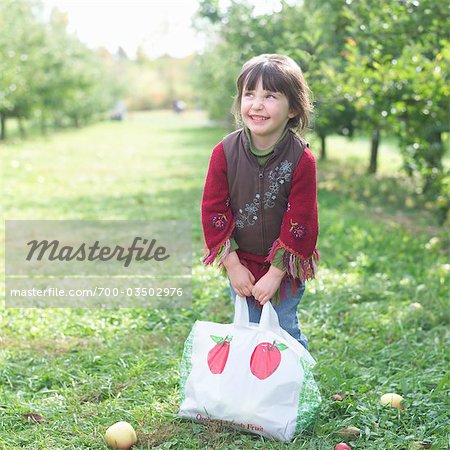 Little Girl in Apple Orchard