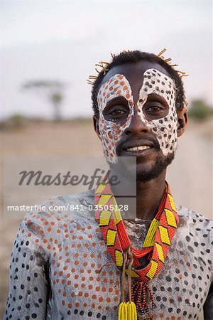 Portrait of a Karo tribesman, with face and body painted with chalk to represent the spotted plumage of the guinea fowl, Omo river, Lower Omo Valley, Ethiopia, Africa