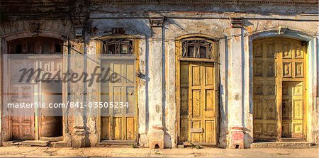 Facades of dilapidated colonial buildings bathed in evening light, Havana, Cuba, West Indies, Central America