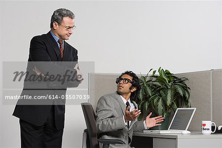 Boss watching over businessman