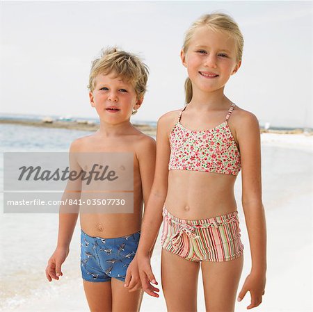 Boy and girl (6-8) on beach