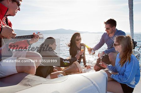 Friends with champagne on yacht