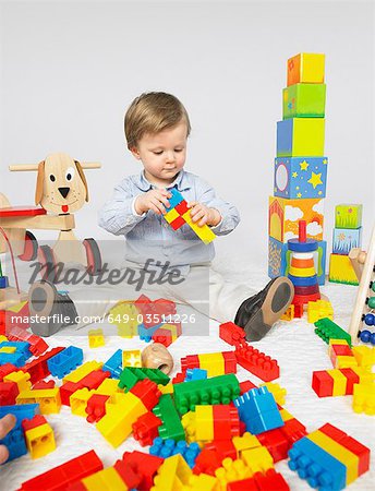 Toddler with many toys