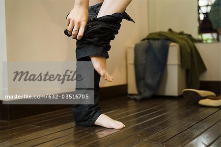 Woman trying on jeans in fitting room