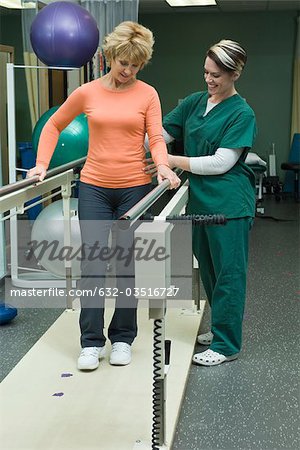 Woman undergoing post-surgery rehabilitation exercises to regain ability to walk