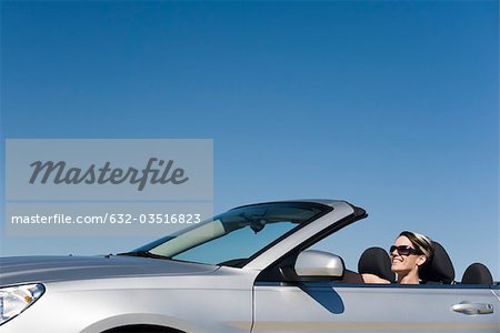 Woman out for pleasure drive in convertible