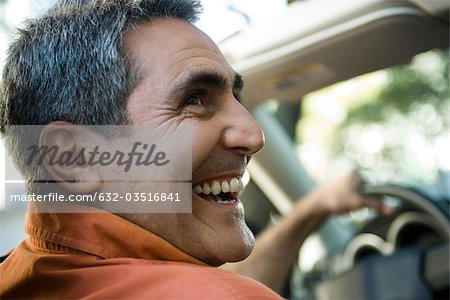 Mature man driving with look of happiness