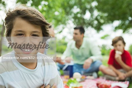 Boy having picnic with family, portrait