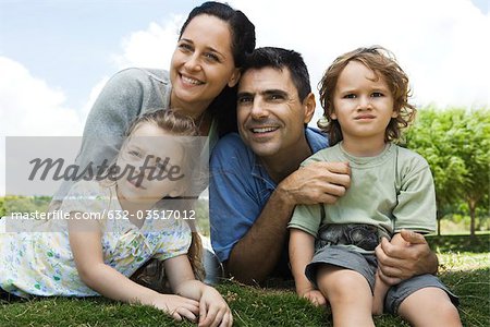 Family relaxing together outdoors, portrait