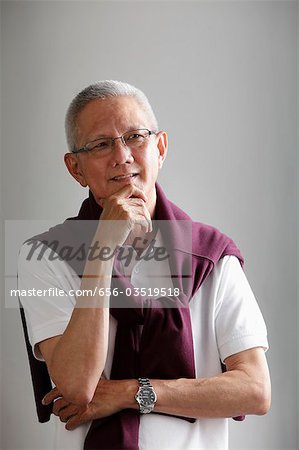 head shot of mature man with grey hair thinking