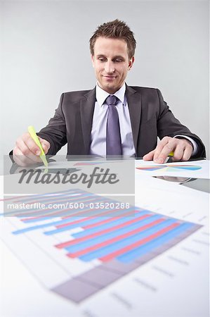 Businessman Looking at Graphs