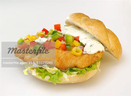 Escalope, salad, diced peppers and remoulade in bread roll