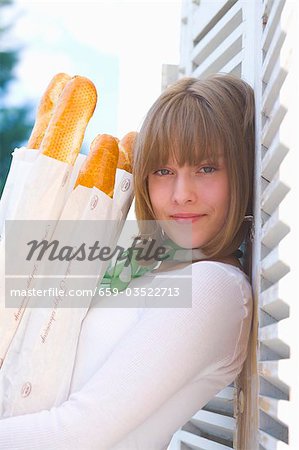 Young woman with baguettes