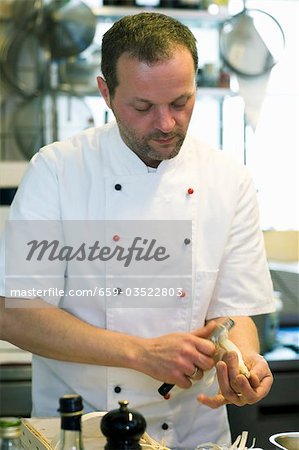 Chef peeling asparagus