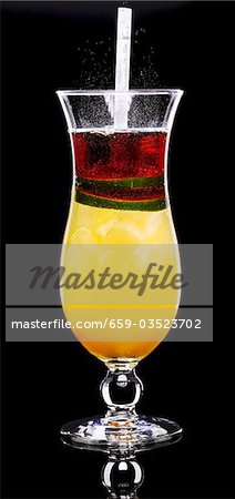 A glass of orange cocktail A glass of orange cocktail