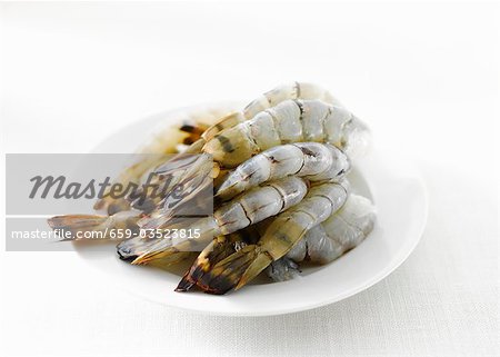 Raw, peeled prawns on a plate